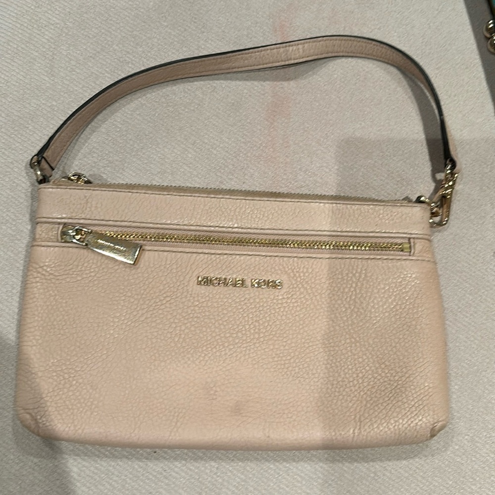 Michael Kors wristlet in pale pink with gold accents